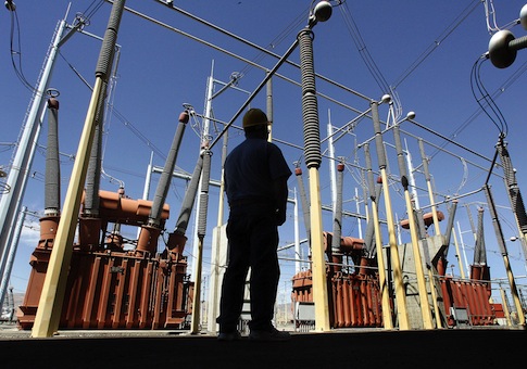 Worker looks over transformers at the Bonneville Power Administration's Celilo Converter Station / AP