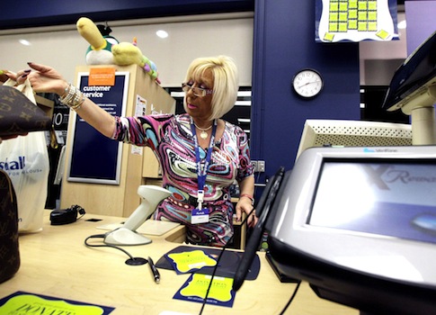 A cashier works at a Marshalls in Chicago / AP