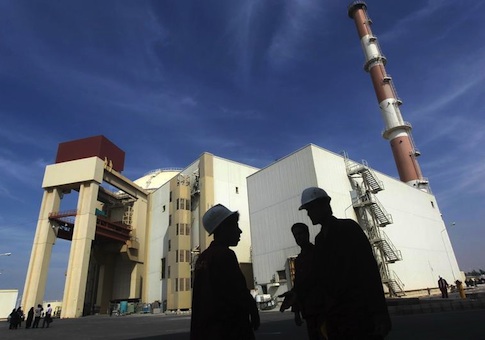 Iranian workers stand in front of Bushehr nuclear power plant