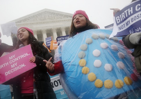 Protestor wears a birth control pills costume outside of Supreme Court during Hobby Lobby's oral arguments / AP