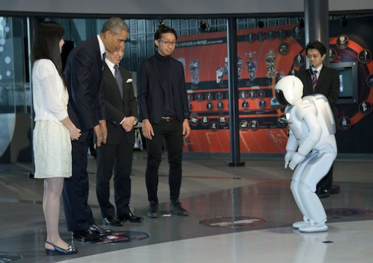 President Barack Obama bows to a Japanese robot. (AP)