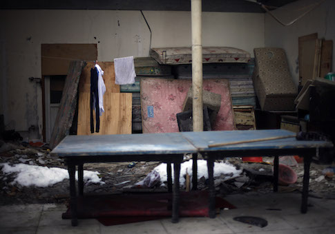 Wet mattresses are stacked inside the site of a former black jail where a young woman claims she was raped while being illegally detained in Beijing, China / AP