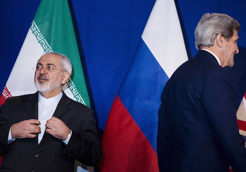 Iranian Foreign Minister Zarif waits to make a statement next to U.S. Secretary of State Kerry following nuclear talks in Lausanne