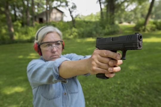 Woman with gun / AP