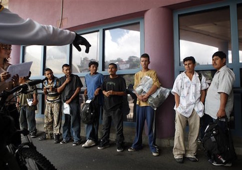A group of illegal immigrants listen to a Border Patrol agent while being deported to Mexico at the Nogales Port of Entry in Nogales, Ariz.