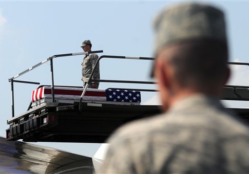 A transfer case containing the remains of Army 1st Lt. Michael L. Runyan sits on a loader Saturday, July 24, 2010 at Dover Air Force Base, Del. Runyan died in Iraq of injuries sustained when insurgents attacked his convoy vehicle with an improvised explosive / AP