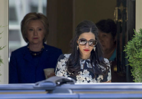 Huma Abedin, right, followed by Hillary Clinton / AP