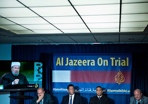 David Pollock, fellow at the Washington Institute, Mohamed Fawzi, former Al Jazeera English cameraman, Mohamed Fahmy, Al Jazeera English reporter, and lawyer Martin McMahon hold a press conference at the National Press Club about a lawsuit against Qatar's Al Jazeera June 22