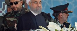 Iranian President Hassan Rouhani sits among senior army staff