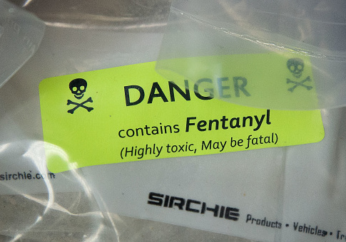 Bags of heroin, some laced with fentanyl, are displayed /