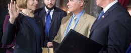 Sen. Tina Smith (L) is ceremonially sworn in by Vice President Mike Pence