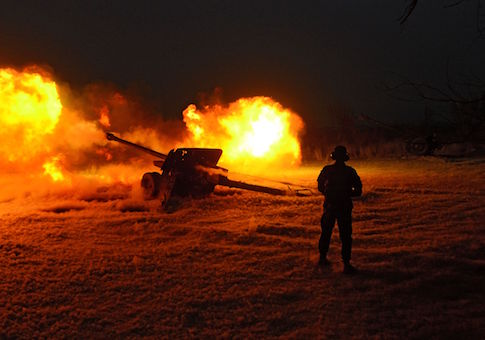 An Afghan National Army soldier fires an artillery shell during an ongoing anti-Taliban operation at Farah province