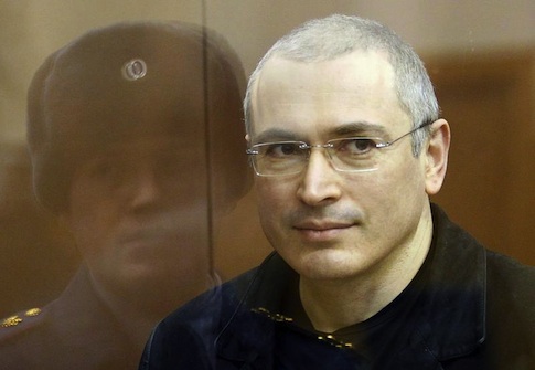 Jailed Russian former oil tycoon Mikhail Khodorkovsky stands in the defendants' cage before the start of a court session in Moscow