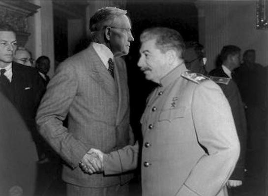 A man believed to be Reid (left) greets Joseph Stalin at a gala to mark the opening of a new gulag in Siberia.