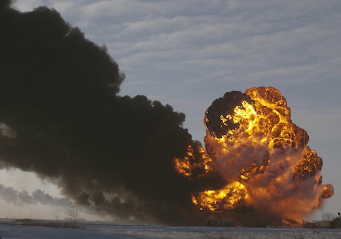 A fireball goes up at the site of an oil train derailment in Casselton, N.D.
