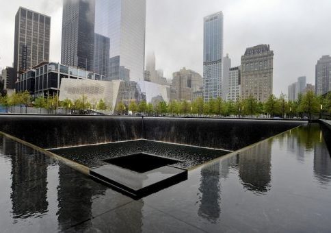 A view of the National September 11 Memorial Museum with the north reflecting pool in foreground