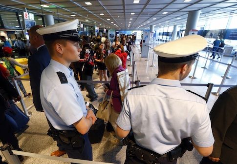 Police officers patrol at a security gate inside the main terminal of Frankfurt Airport