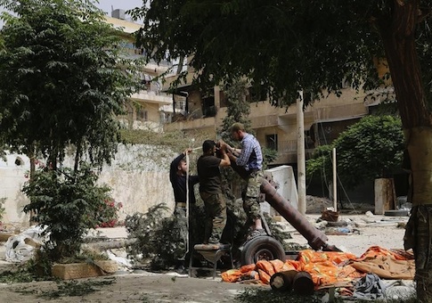 Members of Islamist rebel group Nusra Front prepare a home made mortar in Aleppo's Bustan al-Qasr neighborhood