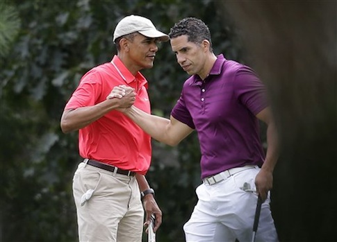 President Barack Obama, left, shakes hands with Cyrus Walker, cousin of White House senior adviser Valerie Jarrett, while golfing at Farm Neck Golf Club in Oak Bluffs, Mass., on the island of Martha's Vineyard