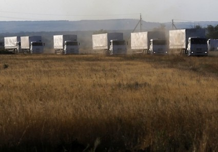 Trucks of a Russian convoy carrying humanitarian aid for Ukraine drive before parking at a camp near Donetsk located in Rostov Region, August 21