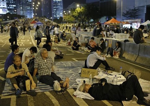 Protesters take a rest during a rally in the occupied areas at Central district in Hong Kong, Thursday, Oct. 9