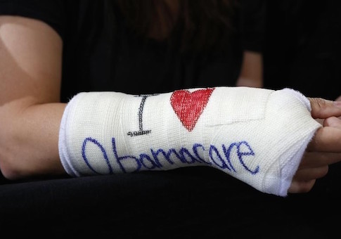 Cathey Park of Cambridge, Massachusetts wears a cast for her broken wrist with ''I Love Obamacare''