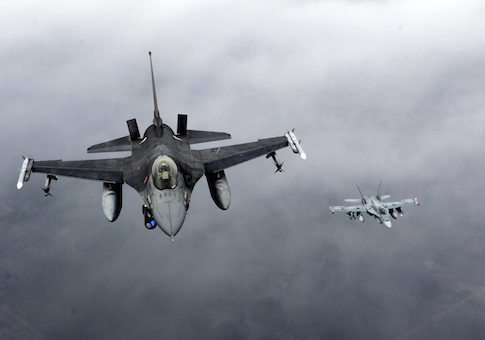 Portuguese Air Force fighter F-16 (L) and Canadian Air Force fighter CF-18 Hornet patrol over Baltics air space