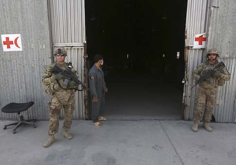 U.S. troops stand guard in front of a police medical warehouse in Kabul