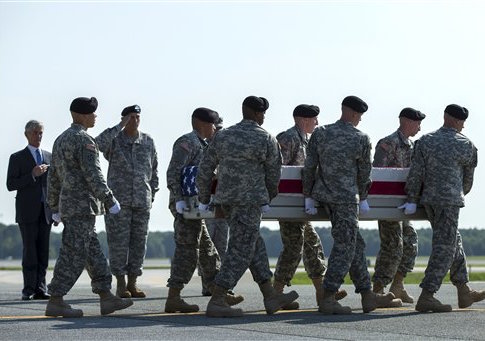 Secretary of the Army John McHugh, left, and Army Chief of Staff Gen. Ray Odierno, third from left, watch an Army carry team transfers the remains of Army Maj. Gen. Harold Greene at Dover Air Force Base, Del., Thursday, Aug. 7, 2014