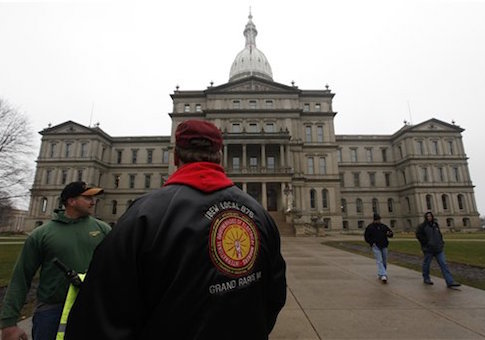 International Brotherhood of Electrical Workers members stand outside the capitol in Lansing, Friday, Dec. 7, 2012