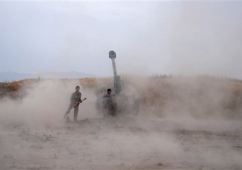 Afghan National Army soldiers fire artillery during a battle with Taliban insurgents in the Chahardara district of Kunduz province northern of Kabul, Afghanistan, Sunday, May 3