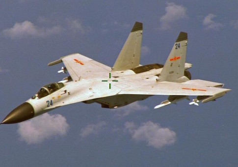 A Chinese J-11 fighter jet is seen flying near a U.S. Navy P-8 Poseidon east of China's Hainan Island