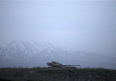 An old Israeli tank sits in a position in the Israeli-controlled Golan Heights near the border with Syria, Tuesday, Jan. 27, 2015