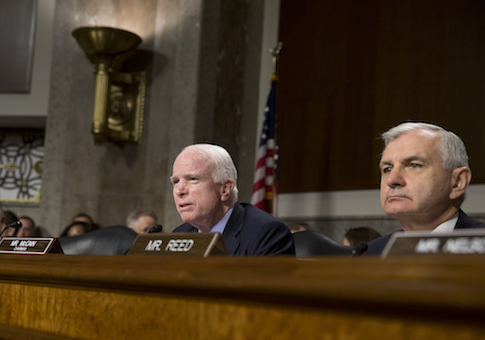 Senate Armed Services Committee Chairman Sen. John McCain, R-Ariz., joined by the committee's ranking member Sen. Jack Reed, speaks during the Senate Armed Services Committee hearing on Capitol Hill in Washington, Tuesday, July 7