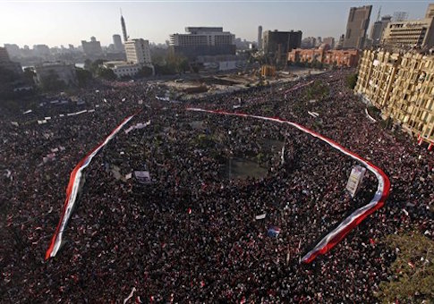 A long Egyptian flag is held by the crowd around Tahrir Square in Cairo, Egypt, Friday Feb. 18, 2011