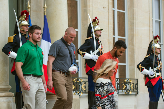 U.S. National Guardsman from Roseburg, Oregon, Alek Skarlatos,  left, U.S. Airman Spencer Stone, 2nd left, and Anthony Sadler, right, a senior at Sacramento University in California, leave the Elysee Palace in Paris, France, with U.S. Ambassador to France Jane D. Hartley after being awarded with the French Legion of Honor by French President, Francois Hollande