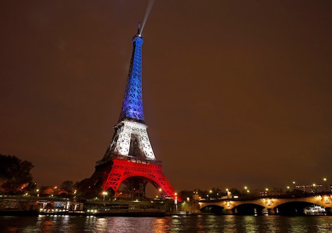 The Eiffel Tower is lit with the blue, white and red colours of the French flag in Paris to pay tribute to the victims of a series of deadly attacks in the French capital