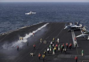 A U.S. Navy fighter jet takes off from the deck of the U.S.S. Dwight D. Eisenhower aircraft carrier