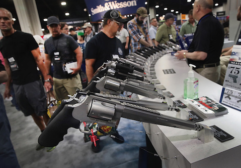 National Rifle Association members look over pistols in the Smith & Wesson display at the 146th NRA Annual Meetings & Exhibits on April 29, 2017 in Atlanta, Georgia