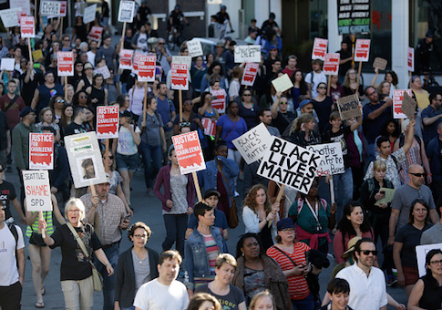 People march in protest to the fatal police shooting of Charleena Lyles, in Seattle