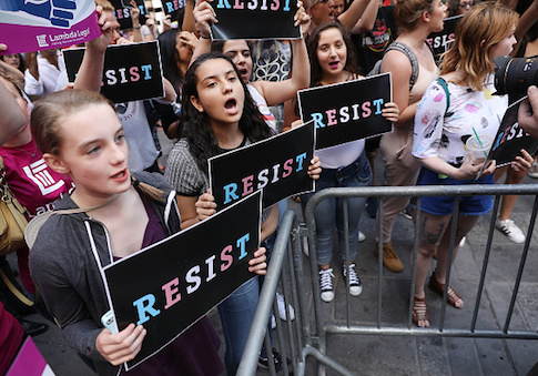 Dozens of protesters gather in Times Square near a military recruitment center to show their anger at President Donald Trump's decision to reinstate a ban on transgender individuals