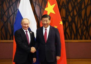 Russian President Vladimir Putin shakes hands with China's President Xi Jinping