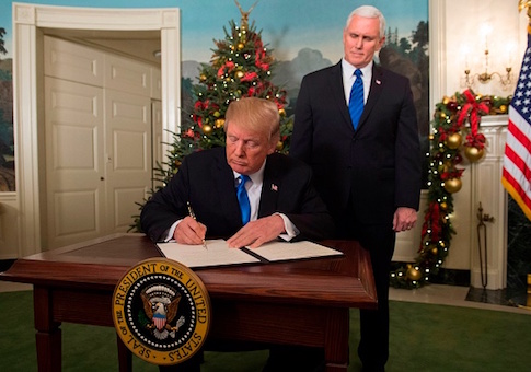 President Donald Trump signs a proclamation after he delivered a statement on Jerusalem as Vice President Mike Pence looks on