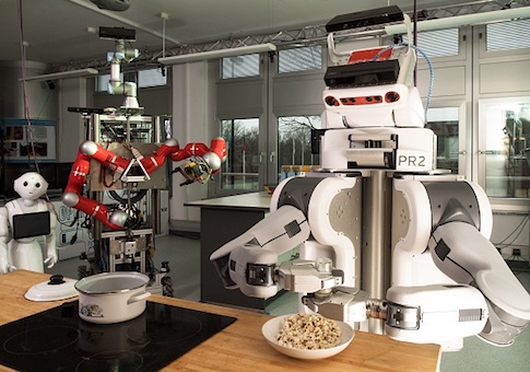 A robot shakes salt over popcorn on March 8, 2017 at the Institute for Artificial Intelligence