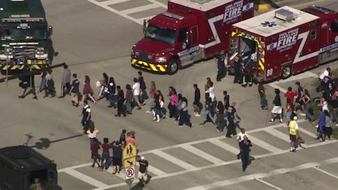 Students are evacuated from Marjory Stoneman Douglas High School during a shooting incident in Parkland, Florida