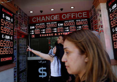People check currency exchange rates at a currency exchange office in Istanbul