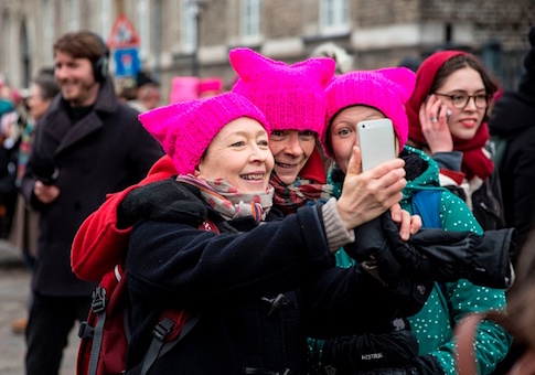 Women wearing the so-called Pussy Hat pose for a selfie