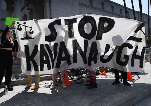 Demonstrators hold anti-Kavanaugh sign