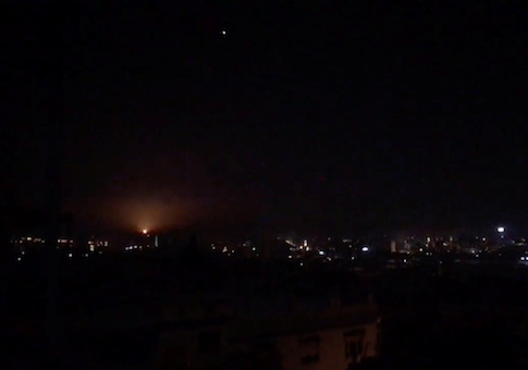 What is believed to be guided missiles are seen in the sky during what is reported to be an attack in Damascus, Syria