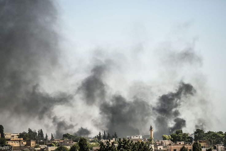 A picture taken in Akcakale at the Turkish border with Syria shows smokes rising from the Syrian town of Tal Abyad
